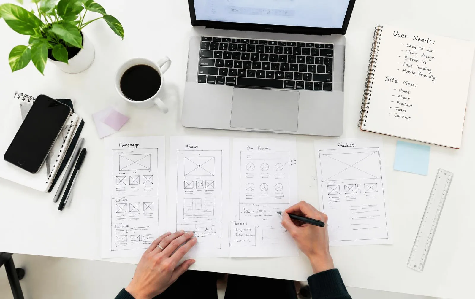 Web designer sketching website wireframes at a desk